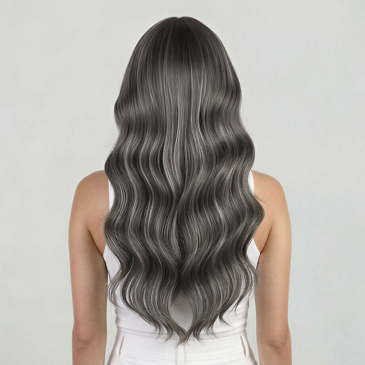 Person with long, wavy, gray hair on a plain background