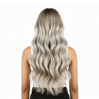 Person with long, wavy, silver hair on a white background