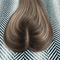 Brown hair extensions on a patterned background